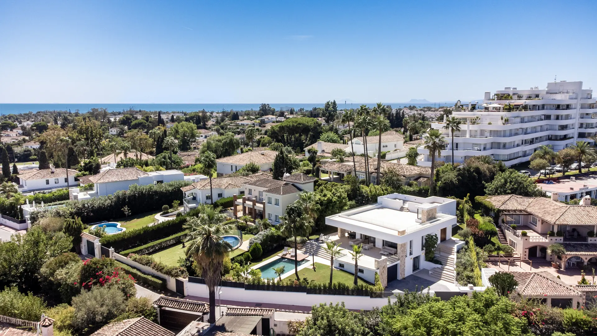 Guadalmina Alta residential area with villas, greenery, and views towards the coastline