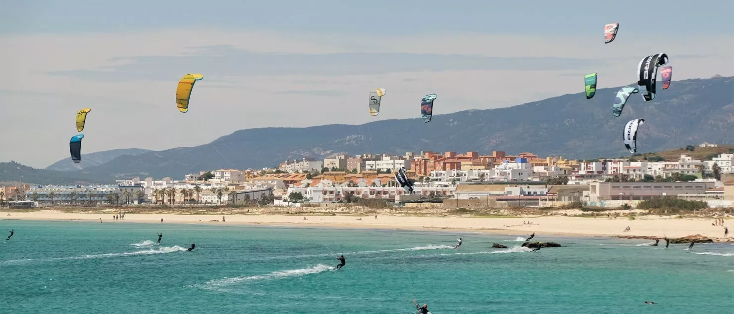 Tarifa coastline with kitesurfers on the water and a wide sandy beach