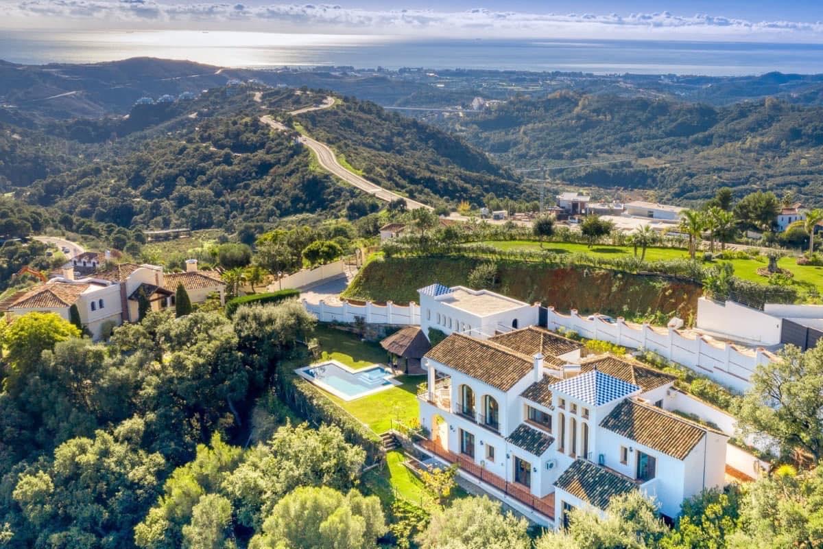 Aerial view of Monte Mayor in Benahavís, surrounded by mountains, valleys, and Mediterranean landscape