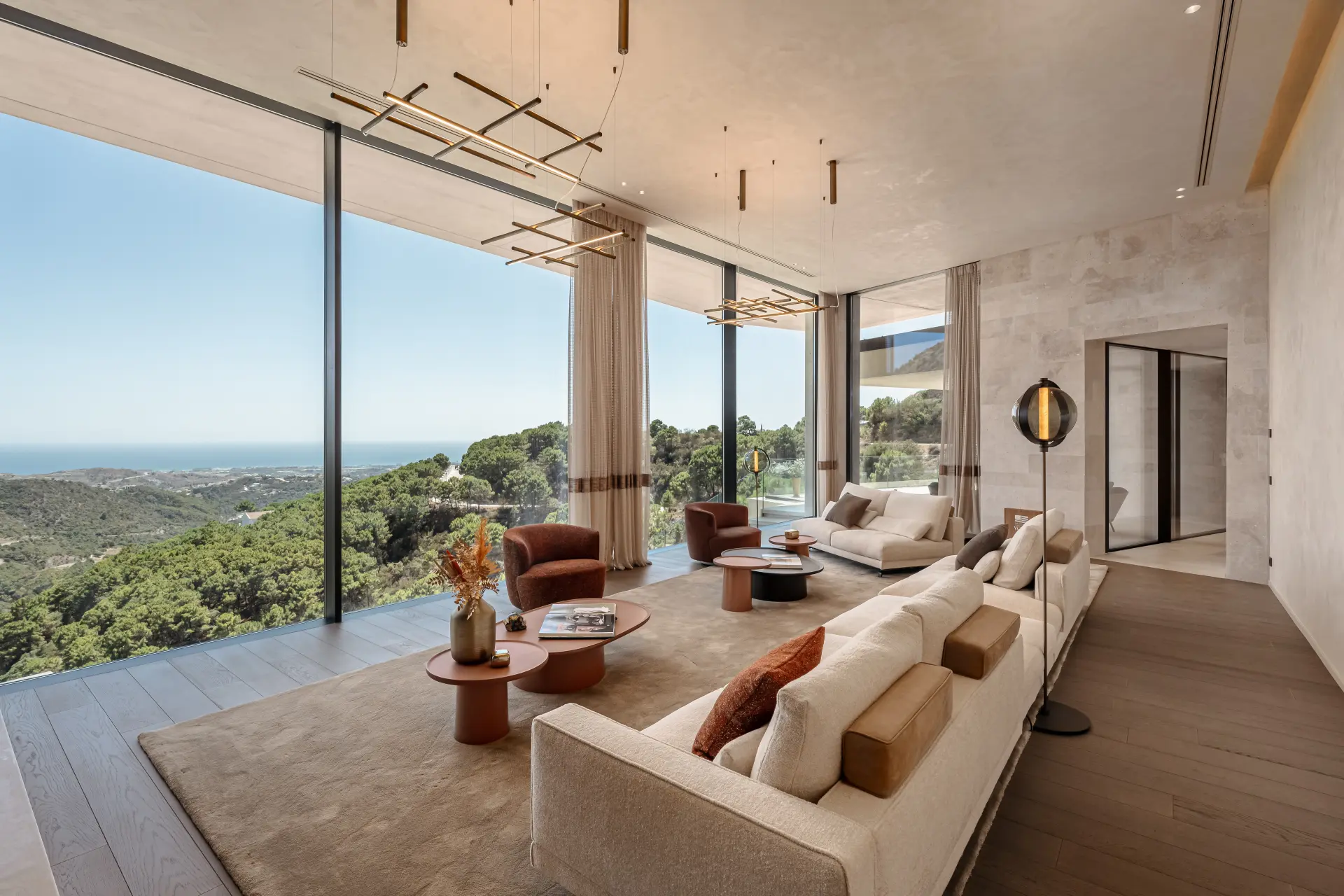 Contemporary living room at Casa Cuiabá in Monte Mayor with floor-to-ceiling windows and panoramic sea and mountain views
